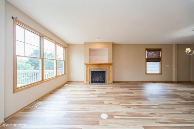 8318 Boulder Dr, West Des Moines, IA 50266 - unfurnished living room with light wood-type flooring and a fireplace