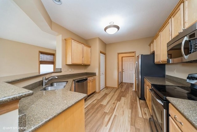 8318 Boulder Dr, West Des Moines, IA 50266 - kitchen featuring stainless steel appliances, light brown cabinets, light wood finished floors, and stone countertops