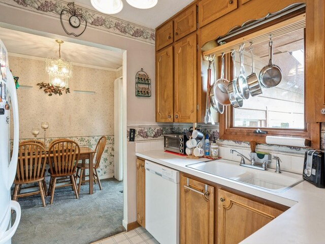 2400 Farwell Rd, Des Moines, IA 50317 - kitchen with white appliances, wallpapered walls, a chandelier, light countertops, and brown cabinets