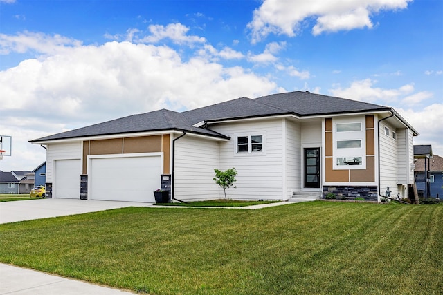 309 NW Beechwood Dr, Grimes, IA 50111 - prairie-style home featuring entry steps, a garage, stone siding, concrete driveway, and a front lawn