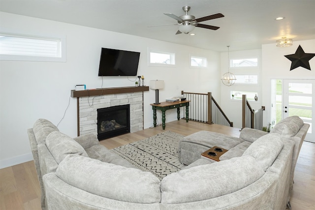 309 NW Beechwood Dr, Grimes, IA 50111 - living area with wood finished floors, recessed lighting, ceiling fan, a chandelier, and a fireplace
