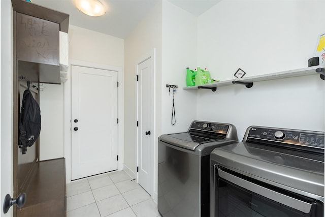 309 NW Beechwood Dr, Grimes, IA 50111 - laundry area with washer and clothes dryer and light tile patterned floors