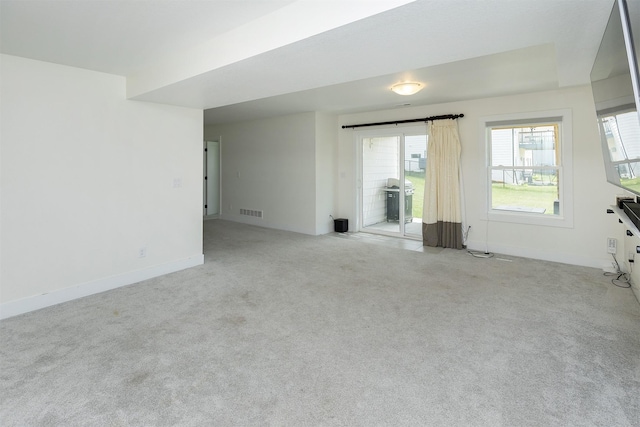 309 NW Beechwood Dr, Grimes, IA 50111 - unfurnished living room featuring baseboards and light colored carpet