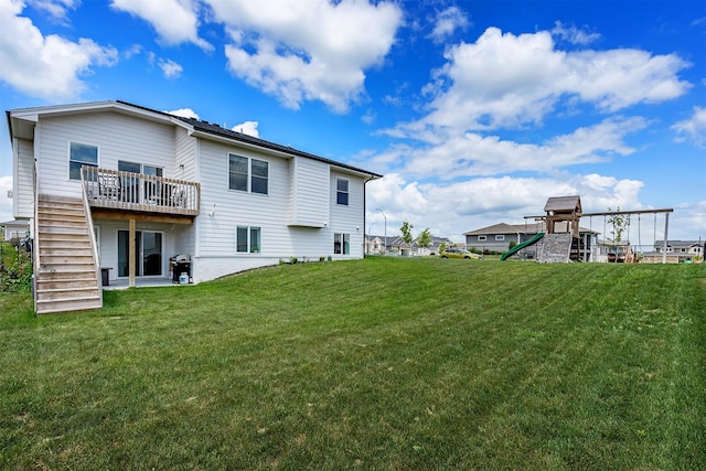 309 NW Beechwood Dr, Grimes, IA 50111 - back of house featuring a playground, a lawn, stairs, and a deck