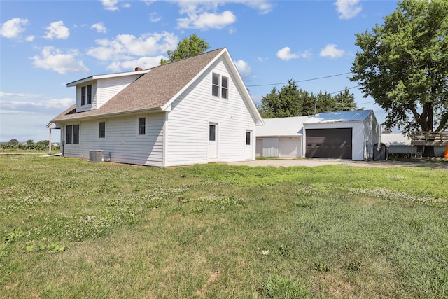 7404 Sioux Ave, Reasnor, IA 50232 - view of property exterior featuring an outdoor structure, a garage, a lawn, and roof with shingles