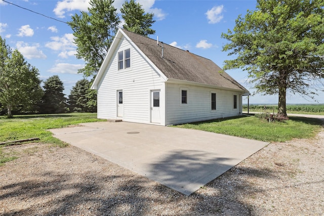 7404 Sioux Ave, Reasnor, IA 50232 - view of property exterior featuring a lawn, a patio, and a shingled roof