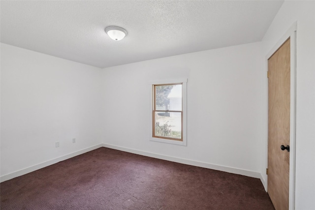 7404 Sioux Ave, Reasnor, IA 50232 - unfurnished room featuring dark colored carpet and a textured ceiling