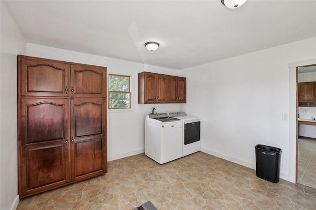 7404 Sioux Ave, Reasnor, IA 50232 - laundry room featuring cabinet space, washer and dryer, and light stone finish flooring