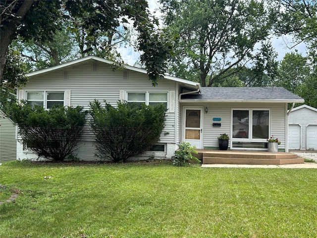 7116 Maple Dr, Urbandale, IA 50322 - view of front of home with a front lawn and a detached garage