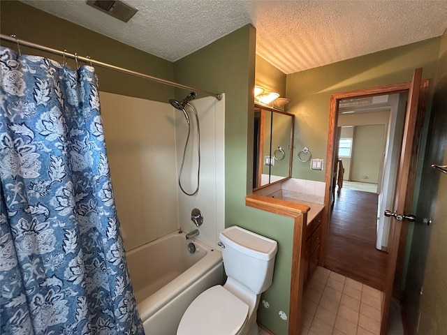 7116 Maple Dr, Urbandale, IA 50322 - bathroom featuring shower / bath combo, tile patterned floors, a textured ceiling, and vanity