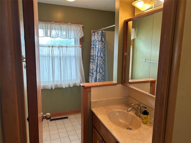7116 Maple Dr, Urbandale, IA 50322 - bathroom featuring vanity, tile patterned floors, decorative backsplash, a textured ceiling, and a shower with shower curtain