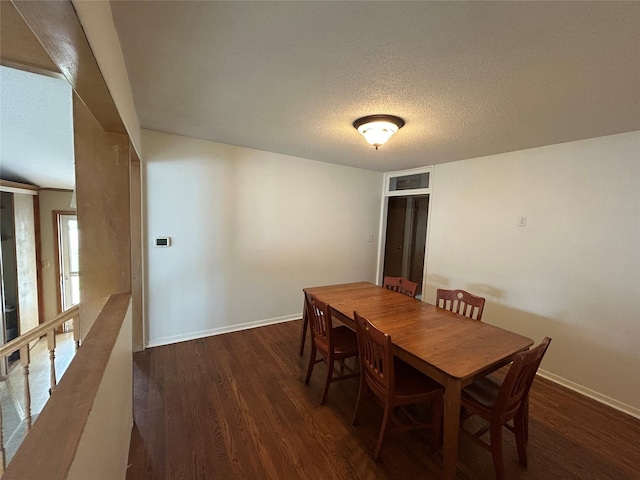 7116 Maple Dr, Urbandale, IA 50322 - dining room featuring dark wood-type flooring and a textured ceiling