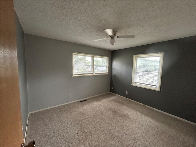 7116 Maple Dr, Urbandale, IA 50322 - carpeted spare room with a ceiling fan and a textured ceiling