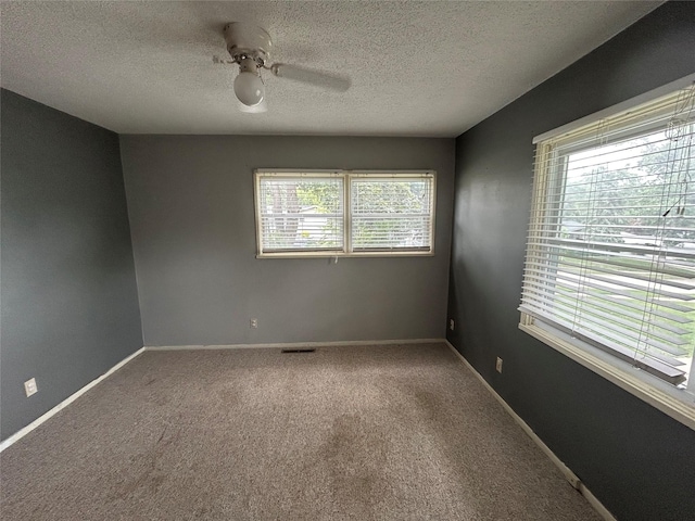 7116 Maple Dr, Urbandale, IA 50322 - empty room with a ceiling fan, carpet flooring, and a textured ceiling