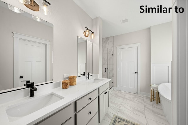 3217 NW Prescott Ct, Grimes, IA 50111 - full bathroom featuring marble finish flooring, a shower stall, a freestanding tub, and double vanity