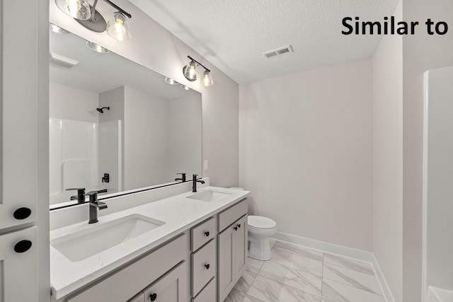 3217 NW Prescott Ct, Grimes, IA 50111 - bathroom with marble finish floors, double vanity, a shower, and a textured ceiling