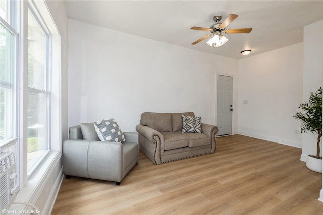 1547 13th St, Des Moines, IA 50314 - living room with light wood finished floors and a ceiling fan