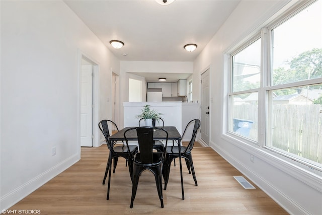 1547 13th St, Des Moines, IA 50314 - dining room featuring baseboards and light wood finished floors