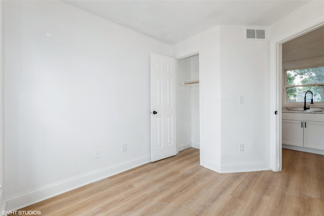 1547 13th St, Des Moines, IA 50314 - unfurnished bedroom featuring light wood-type flooring and a closet