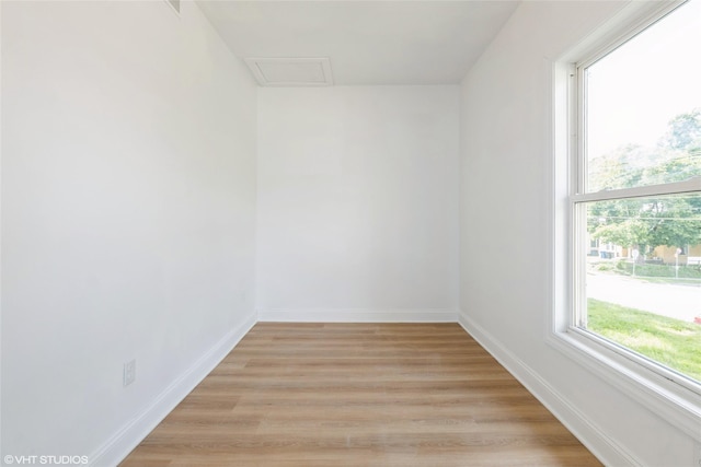1547 13th St, Des Moines, IA 50314 - empty room with attic access and light wood-type flooring