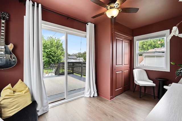 1315 Bundy St, Des Moines, IA 50315 - bedroom with access to exterior, light wood-style floors, and a ceiling fan