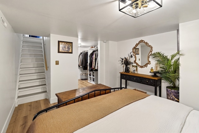 1315 Bundy St, Des Moines, IA 50315 - bedroom featuring wood finished floors, a chandelier, a closet, and a spacious closet