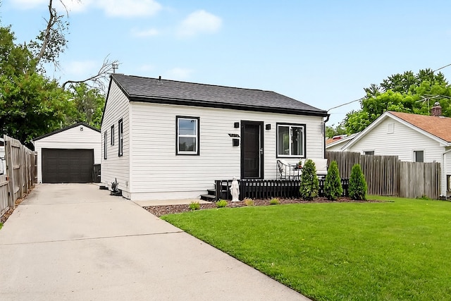 1315 Bundy St, Des Moines, IA 50315 - view of front of home with an outbuilding, a detached garage, and concrete driveway