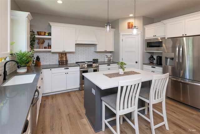 807 W Orchard Ave, Indianola, IA 50125 - kitchen featuring appliances with stainless steel finishes, custom range hood, open shelves, recessed lighting, and white cabinetry