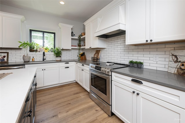 807 W Orchard Ave, Indianola, IA 50125 - kitchen with electric range, premium range hood, dark countertops, white cabinets, and open shelves