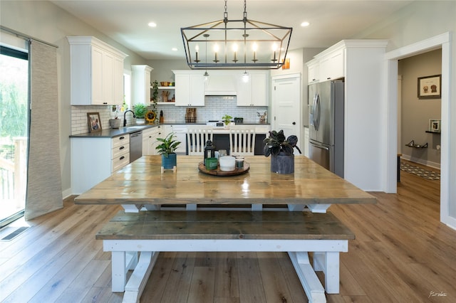 807 W Orchard Ave, Indianola, IA 50125 - dining room with light wood-type flooring, a chandelier, and recessed lighting