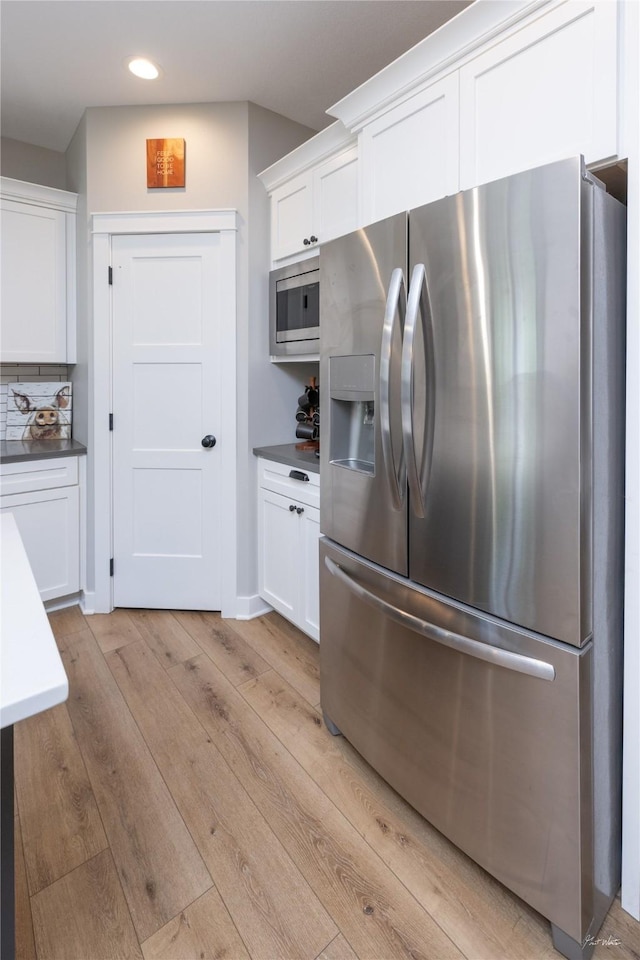 807 W Orchard Ave, Indianola, IA 50125 - kitchen with stainless steel appliances, light wood-type flooring, white cabinetry, and recessed lighting