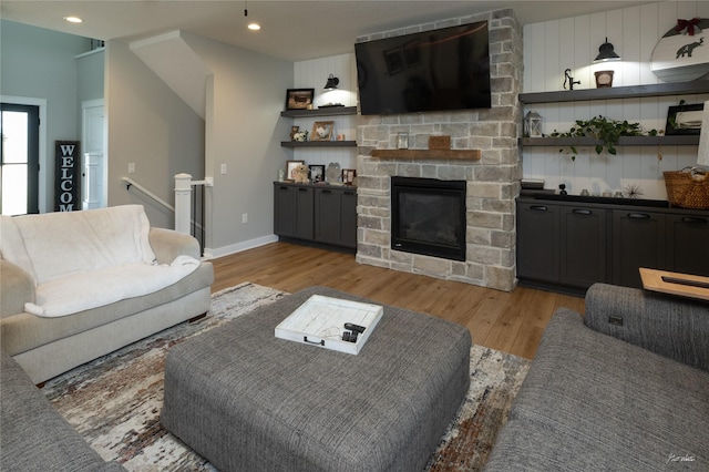 807 W Orchard Ave, Indianola, IA 50125 - living area featuring light wood-style floors, a stone fireplace, and recessed lighting