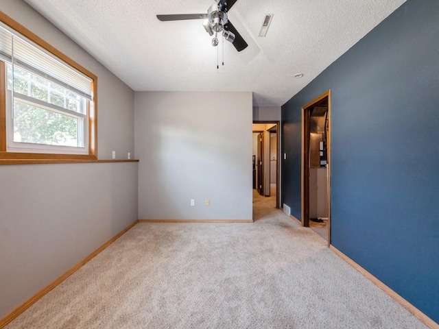 808 SW 2nd St, Stuart, IA 50250 - carpeted spare room with ceiling fan and a textured ceiling