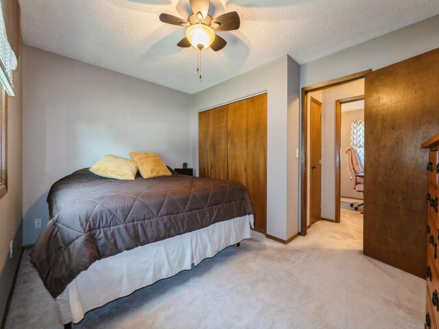 808 SW 2nd St, Stuart, IA 50250 - bedroom featuring a closet, light carpet, a textured ceiling, and a ceiling fan
