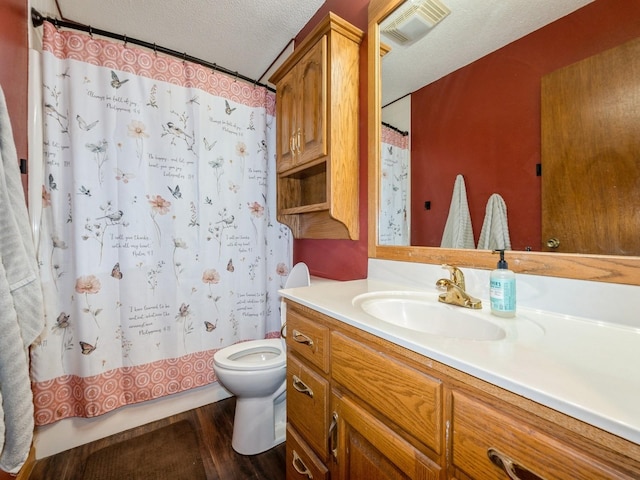 808 SW 2nd St, Stuart, IA 50250 - bathroom with vanity, a textured ceiling, and wood finished floors