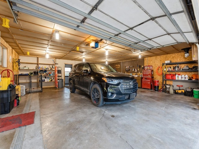 808 SW 2nd St, Stuart, IA 50250 - garage with a garage door opener and a workshop area