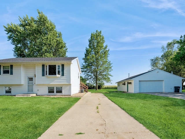 808 SW 2nd St, Stuart, IA 50250 - bi-level home with a garage, a front lawn, and an outdoor structure