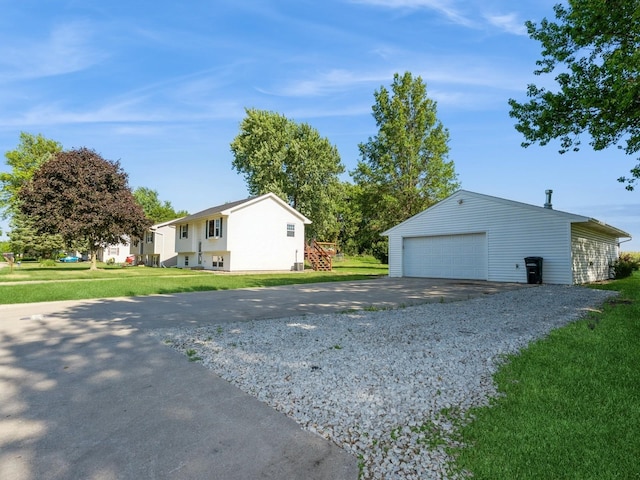 808 SW 2nd St, Stuart, IA 50250 - view of side of home featuring a detached garage, an outdoor structure, and a yard