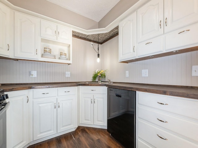 808 SW 2nd St, Stuart, IA 50250 - kitchen with black dishwasher, dark wood-type flooring, white cabinets, and stainless steel range