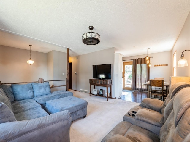 808 SW 2nd St, Stuart, IA 50250 - living room featuring light carpet and a textured ceiling
