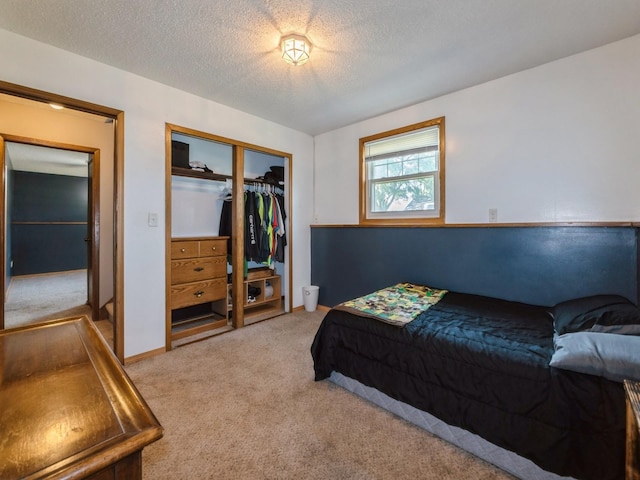 808 SW 2nd St, Stuart, IA 50250 - bedroom featuring light carpet, a closet, and a textured ceiling