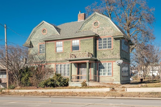 115 W Mclane St, Osceola, IA 50213 - view of front facade featuring a chimney and roof with shingles