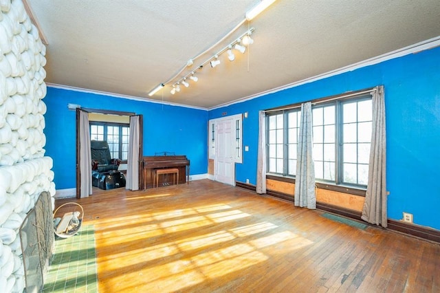 115 W Mclane St, Osceola, IA 50213 - living room with ornamental molding, hardwood / wood-style floors, a fireplace, rail lighting, and a textured ceiling