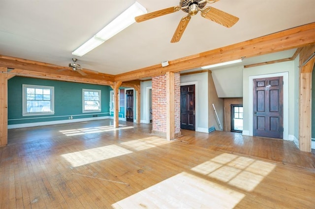 115 W Mclane St, Osceola, IA 50213 - unfurnished living room featuring ceiling fan, wood-type flooring, and healthy amount of natural light