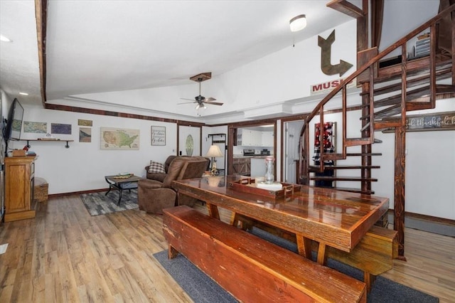 407 E Mckinney St, Runnells, IA 50237 - dining area featuring lofted ceiling, a ceiling fan, wood finished floors, and stairs