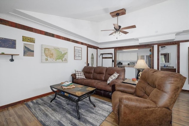 407 E Mckinney St, Runnells, IA 50237 - living room featuring a ceiling fan, wood finished floors, and vaulted ceiling