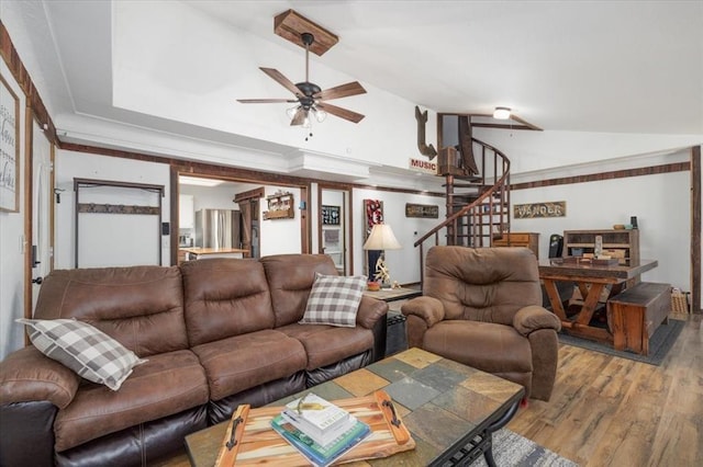 407 E Mckinney St, Runnells, IA 50237 - living area featuring wood finished floors, stairway, ceiling fan, and lofted ceiling