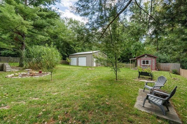 407 E Mckinney St, Runnells, IA 50237 - fenced backyard featuring an outdoor structure and a garage