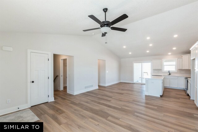 826 31st Ct SW, Altoona, IA 50009 - unfurnished living room featuring recessed lighting, vaulted ceiling, a ceiling fan, and light wood-style floors