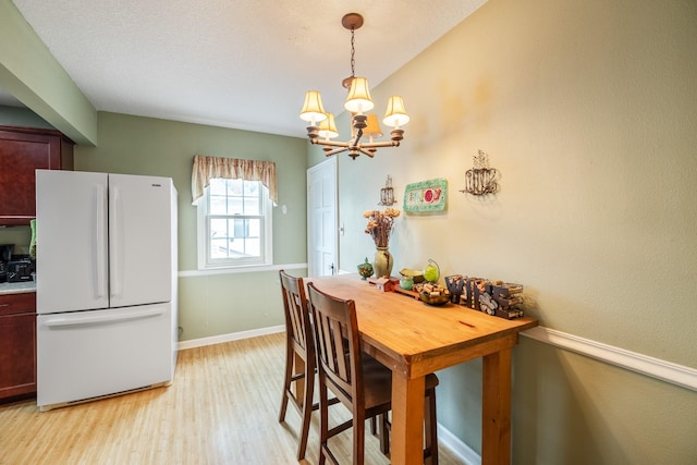 1209 Edgemont St, Des Moines, IA 50315 - dining space with light wood-type flooring and a chandelier